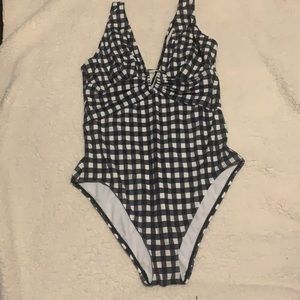 A one-piece bathing suit and low back and keyhole front. White and blue